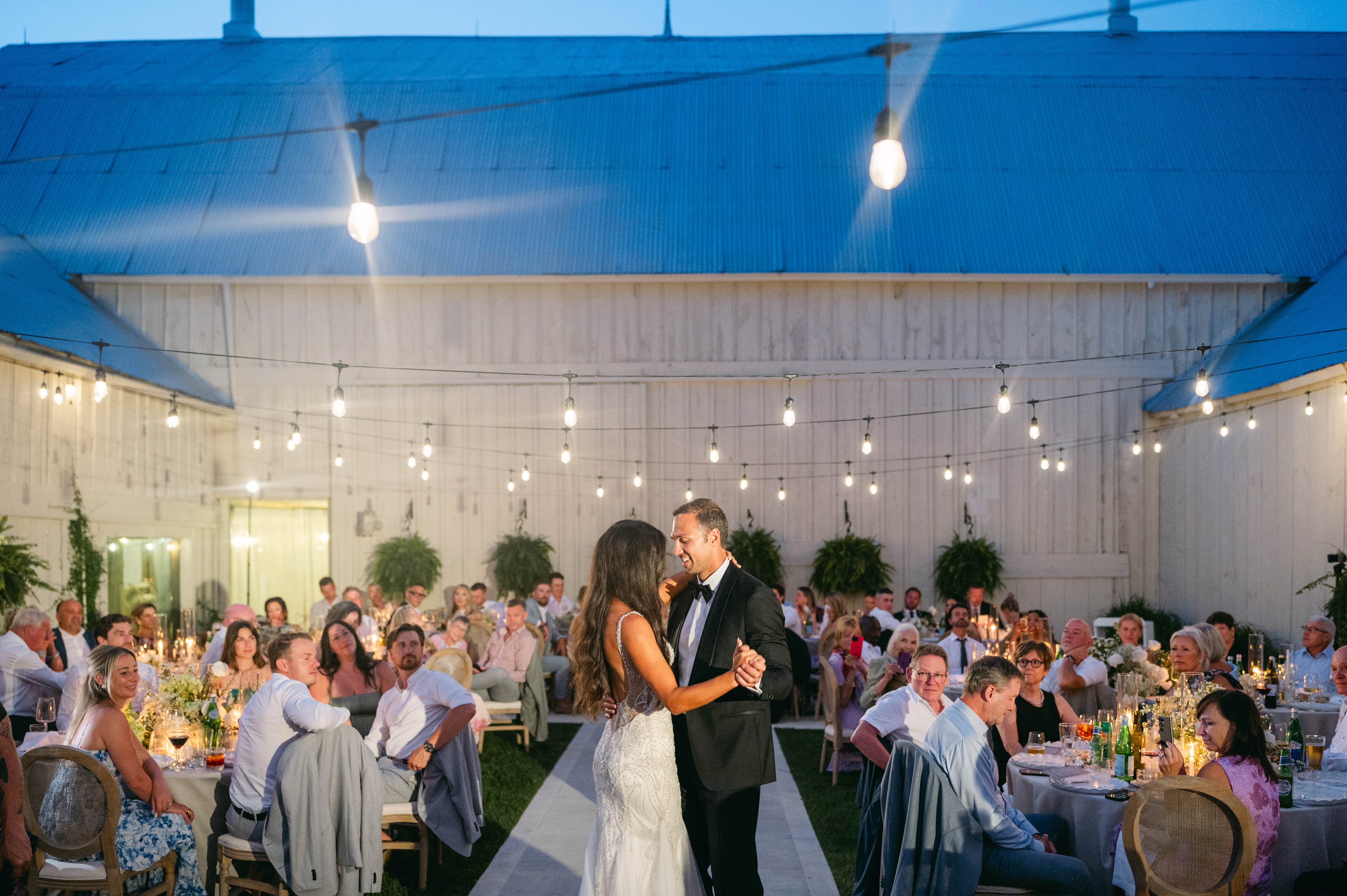 Evening reception at Sorella 1881 — glowing white marquee under a star-filled night sky