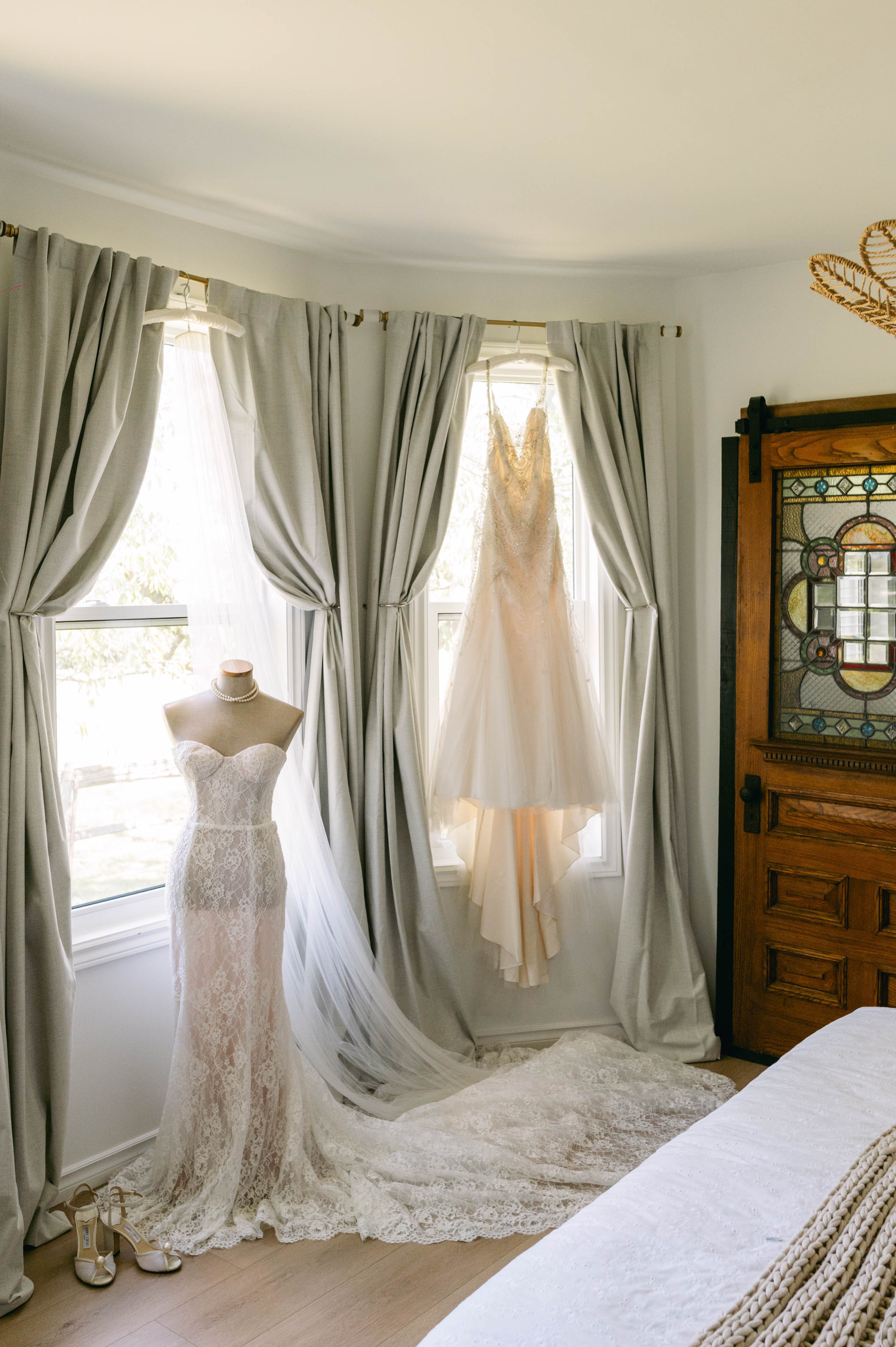 Bridal dress hanging in a bay window inside the Ranch House at Sorella 1881