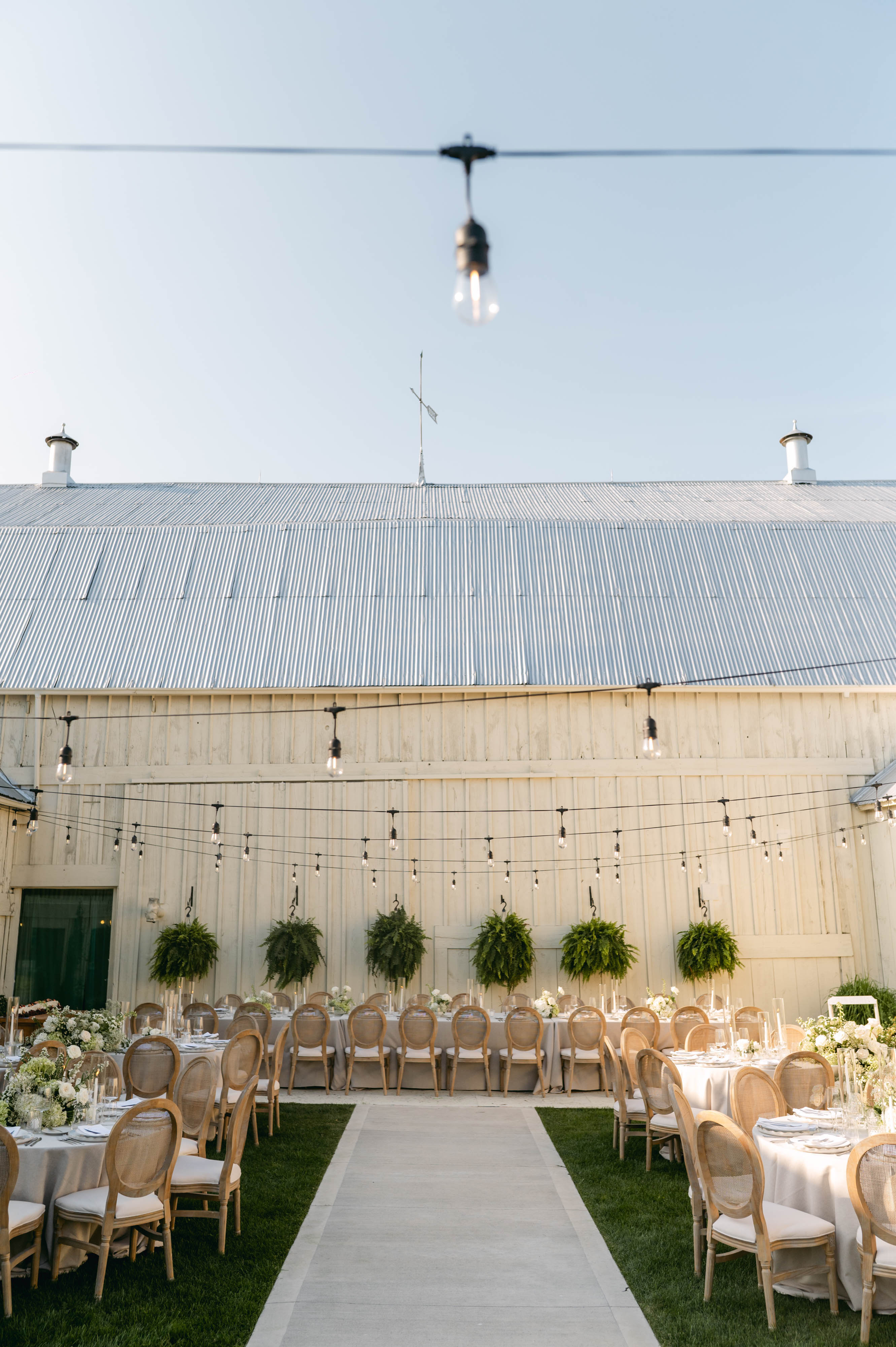 Vertical view of the courtyard reception at Sorella 1881 rising to the peaked barn roof and open sky