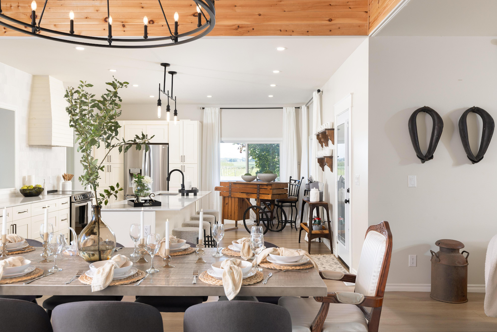 Ranch House open-plan dining and living room at Sorella 1881 — farmhouse interior with set dining table