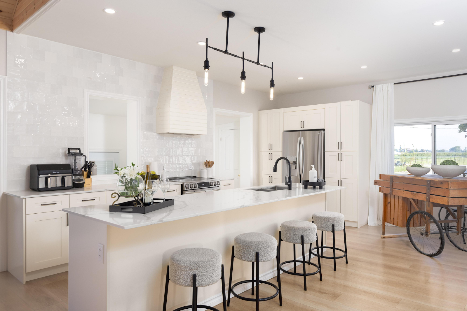 Ranch House kitchen at Sorella 1881 — modern white kitchen with marble countertops and island seating