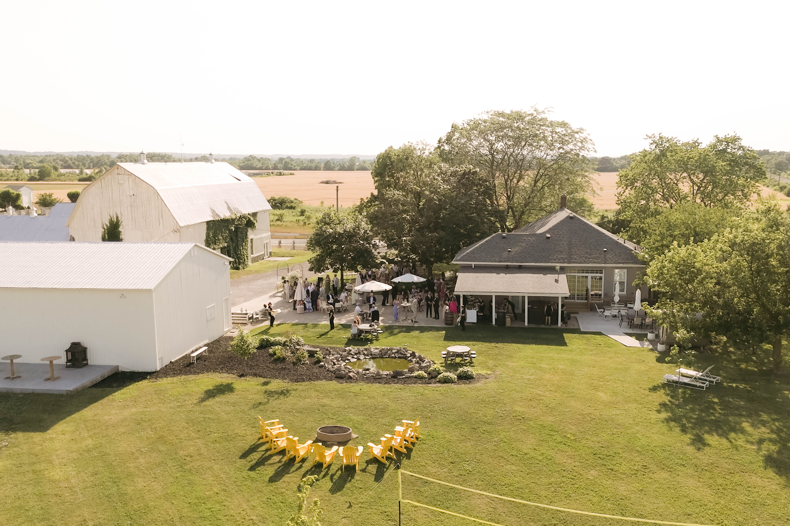 Aerial view of Sorella 1881 estate — white barn and farmhouse surrounded by 30 acres of Niagara farmland